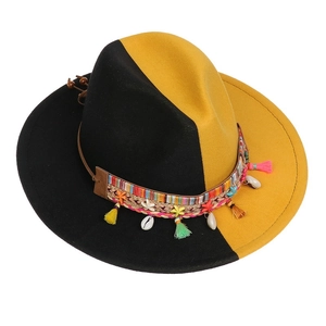 Detail of fedora hat with ethnic woven band, sea shells, and colorful tassels decoration
