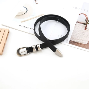 Detail of a slim black belt featuring a matte silver buckle on a minimalist background