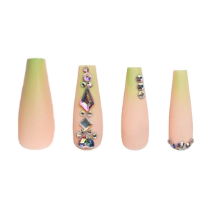 Detailed view of long gradient pink-green press-on nails with sparkling diamond rhinestones