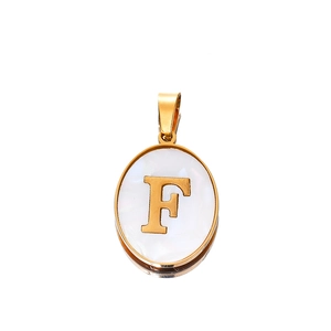 Macro view of oval gold stainless steel pendant featuring a shell-like letter F inlay