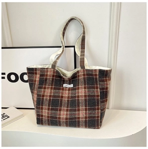 Detail of classic plaid tote bag with Magic Pocket woven label and retro stitching