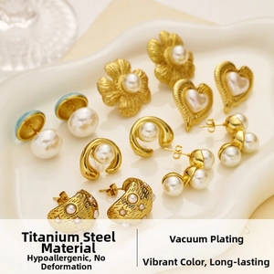 Detailed macro view of 18k gold plated titanium earrings with pearls in various shapes