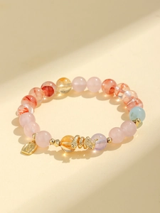Detailed view of colorful amethyst beads with golden snake and lucky charm pendants