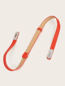Detail view of orange Saffiano leather belt with a silver metallic twist-lock buckle