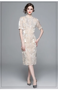 Detail of sequin pendant top and high waist slit skirt set with floral embroidery
