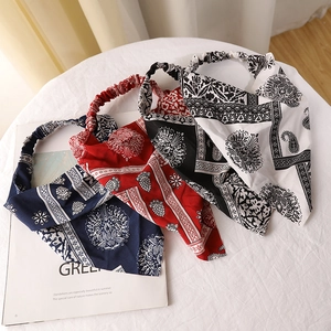 Three paisley printed triangle hair kerchiefs in blue, red, and black floral patterns
