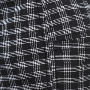 Macro detail of high-quality black and white plaid fabric with fine stitching for beret hat