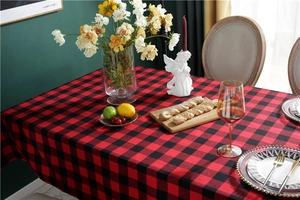 Close-up of red and black buffalo plaid festive tablecloth with woven fabric texture