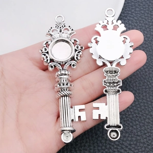Macro detail of vintage silver heart-shaped key pendant with crown motif in palm