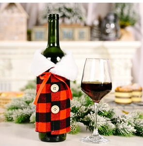 Detail of red and black buffalo plaid wine bottle cover with fur collar and bow