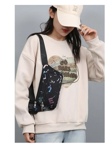 Detail of colorful letter print oxford waist bag worn by model with adjustable strap