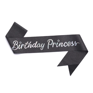 Detail of a black velvet Birthday Princess sash with sparkling silver glitter lettering
