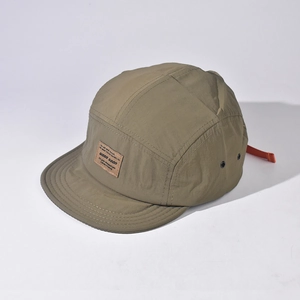 Detail of camper hat featuring orange adjustable strap and breathable metal eyelets