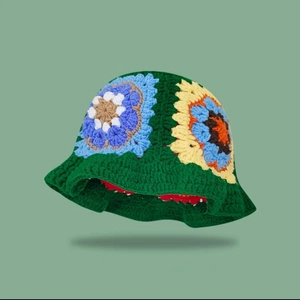 Handmade crochet floral bucket hat in dark green with colorful vintage knitted patterns