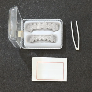 Iced out silver hip-hop grillz set with tweezers and instruction manual in storage box