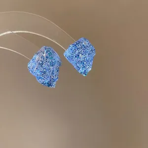 French style sapphire blue irregular resin stud earrings with silver needles on display