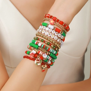 Christmas beaded bracelet set with Santa pendants and Merry Christmas charms on model wrist