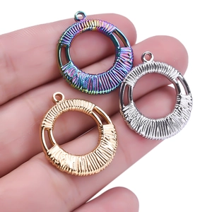 304 stainless steel circular pendants in rainbow gold and silver on a palm