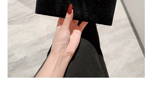 Detail of elegant black velvet rectangular clutch bag with luxurious soft suede texture