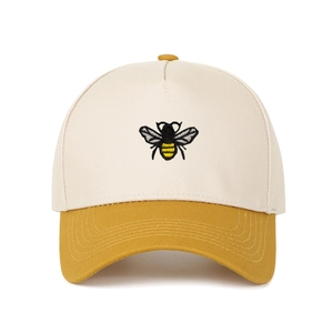 Detailed view of bee embroidery on a two-tone baseball cap with cotton twill texture