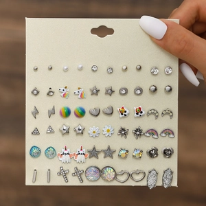 Close-up of 30 pairs stud earrings set featuring bows and flowers on a display card