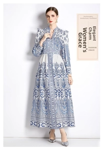Detail of blue and white vintage Paisley print on elegant maxi dress with billowy sleeves