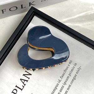 Irregular heart-shaped navy blue acetate hair claw clip with gold metal spring