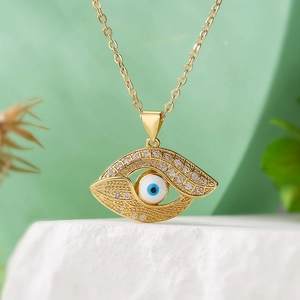Bohemian gold-plated necklace featuring a zircon encrusted evil eye pendant on a stone