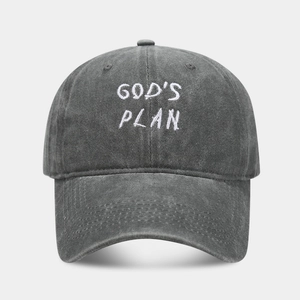 Detail of white GOD'S PLAN embroidery on dark grey washed cotton baseball cap texture
