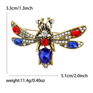 Vintage dragonfly brooch in antique gold with red and blue faceted rhinestones