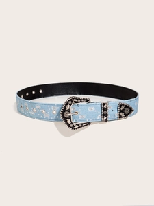 Detailed macro view of blue denim belt featuring silver sequins and ornate western buckle
