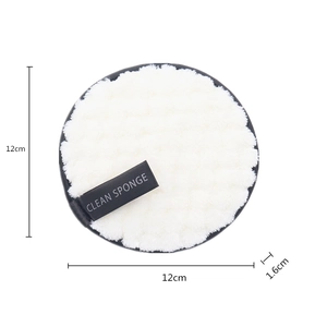 Detail view of round white cleansing sponge with dimensions 12cm diameter and 1.6cm thickness