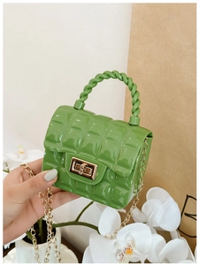 Detailed shot of green quilted PVC jelly bag featuring a golden twist lock and metal chain