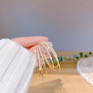 Close-up of sparkling gold multi-hoop earrings with pave-set shimmering crystals