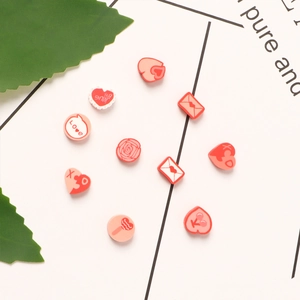 DIY jewelry kit with pink heart beads, rose charms, and LOVE letter beads for bracelets