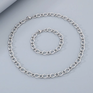 Detailed close-up of a silver stainless steel chain bracelet with heart-shaped ring clasps