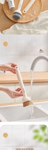 Kitchen dish brush detail with soap dispenser handle and hanging hole for wall storage