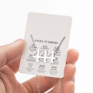 Detailed close-up of silver angel number 444 pendant with stainless steel necklace chain