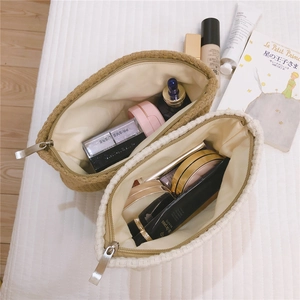Close-up of the interior space and metal zipper of the woven canvas makeup pouch