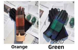 Detail of plaid wool gloves with floral touchscreen embroidery in orange and green tones