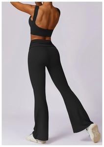 Back view of high waist flared yoga pants and racerback sports bra in black fabric