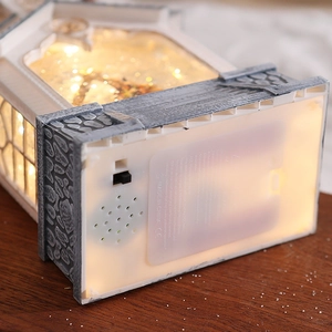 Detail view of the Christmas lantern base featuring battery compartment and music speaker