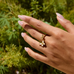 Golden butterfly ring with white crystals and micro-pave diamonds on model's hand
