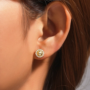 Close-up of gold 925 silver C-shape stud earring with pave diamonds on model ear