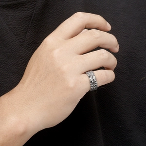 Gothic skull ring for men in vintage stainless steel with chain texture on dark fabric