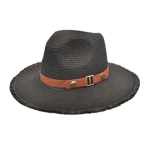 Close-up of black straw sun hat with brown leather belt and golden metal buckle detail