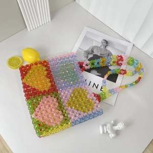 Detail of colorful beaded tote bag with heart pattern and clear acrylic beads texture