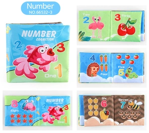 Macro view of soft baby cloth book pages showing colorful numbers and animal illustrations
