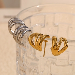 Detail of minimalist 18K gold and silver plated triple-layered curved line stud earrings