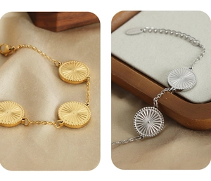Detail of round engraved circular links on 18k gold and silver striped bracelets